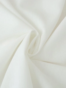 Close-up of the breathable white linen blend fabric texture with soft natural pleats