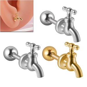 Macro shot of faucet-shaped stainless steel earrings in silver and gold finishes
