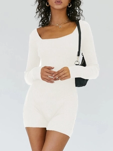 Detail of white ribbed knit long-sleeve yoga romper with square neckline on model