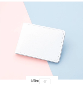 Detailed view of white minimalist leather card holder with fine stitching and 45-degree angle