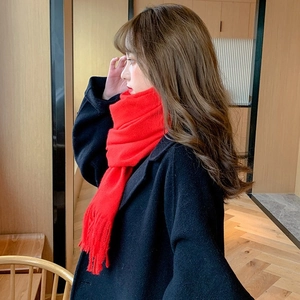 Classic red faux cashmere scarf with tassels paired with a stylish black wool coat