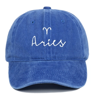 Close-up of Aries embroidery and constellation symbol on vintage blue washed cotton cap