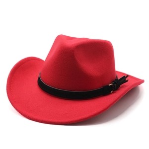 Detail of red wool felt western cowboy jazz hat with black leather band and metal buckle