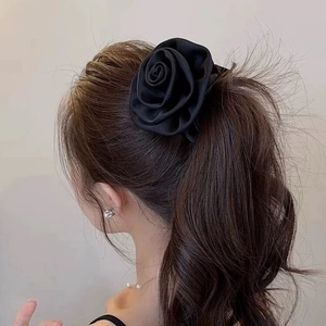 Elegant black satin rose hair scrunchie shown on a ponytail for a vintage French style