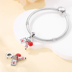 Detail view of silver beaded bracelet with Best Teacher book, apple, and pencil charms