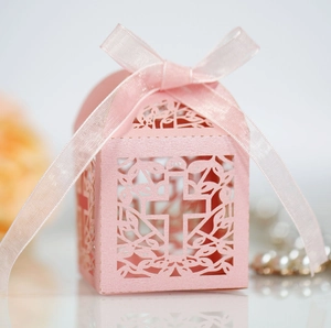 Pink laser-cut cross gift box made of pearlescent paper with a matching satin ribbon