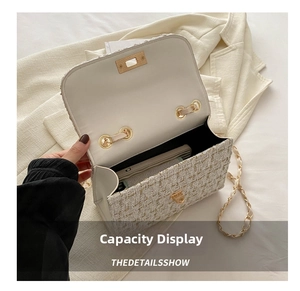 Detail view of white tweed chain bag interior showing capacity for a smartphone