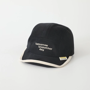 Close-up of black cotton five-panel cap with white tomorrow embroidery and soft brim
