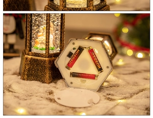 Close-up of the battery compartment and bottom switch on a vintage Christmas snow globe lantern