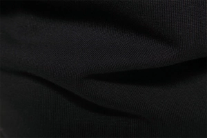 Close-up of premium black knit fabric showing soft texture and high-quality weave pattern