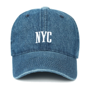 Close-up of NYC white embroidery and distressed denim texture on the baseball cap