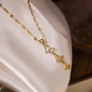 Elegant gold-plated heart necklace set with clear zircon stones on silk background