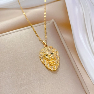 Luxury gold lion head pendant necklace with diamonds and green gem eyes on silk