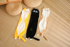 Three long plush cat body pillows in orange, black and brown on a wooden floor