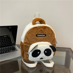 Detailed texture of brown plush panda backpack featuring a silver metal zipper and soft fur