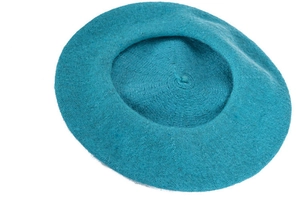 Detail view of teal knitted wool texture on a stylish women's beret cap