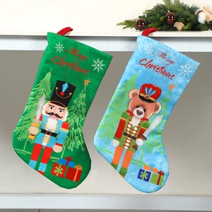 Christmas nutcracker and bear soldier stockings hanging from festive pine branches