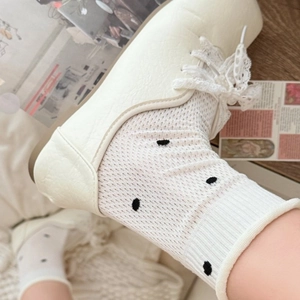 Women's summer white polka dot mesh crew socks styled with lace-up leather shoes