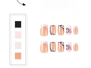 Detail of pink and white French press-on nails with black heart dots and pink glitter accents