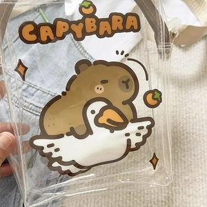 Close-up of clear PVC bag featuring a cute cartoon Capybara riding a white goose