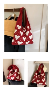 Detail of red knit tote bag with white heart pattern showing texture and stitch quality