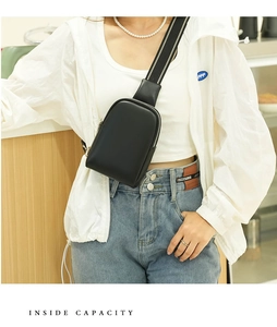 Detail view of mini black PU leather crossbody bag with striped strap and silver zipper