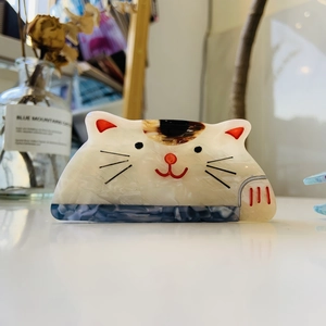 Detailed view of the cute calico cat hair claw clip with a pearlescent acetate finish