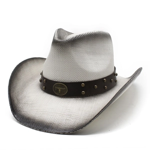Detail of western cowboy hat with bull head metal logo and studded leather band