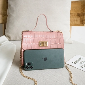 Pink crocodile-embossed handbag with gold chain strap and metallic clasp closure