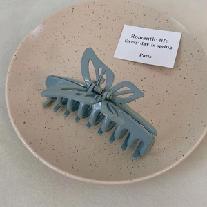 Detail of Morandi blue butterfly hair claw clip with matte finish and secure metal spring