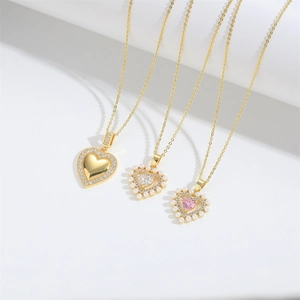 Elegant gold heart pendant necklace set with pearls and zircons on minimalist background