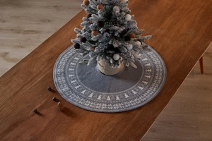 Detail of blue knitted mini Christmas tree skirt with white snowflake and tree patterns