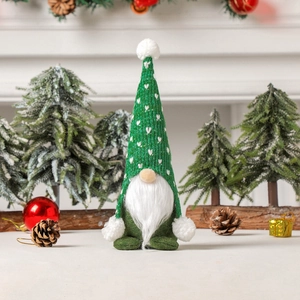 Christmas forest gnome with green knitted heart hat and plush beard on festive background