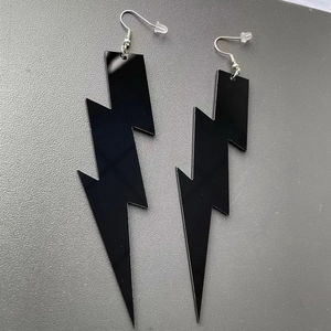 Detail of large black acrylic lightning bolt earrings with silver fishhook ear wires