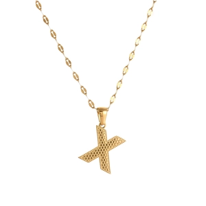 Macro detail of golden letter X pendant with unique honeycomb texture on a fine chain
