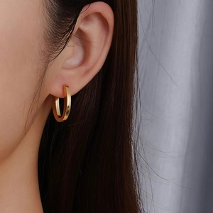 Chic polished gold oval hoop earrings for women featuring a minimalist thick band design