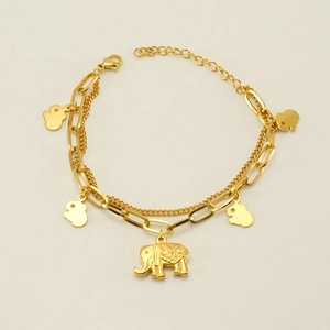 Detail of 18k gold elephant charm bracelet with layered chains and intricate engraving