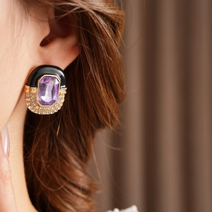 Detail of vintage enamel earrings with purple gem and rhinestones on model ear
