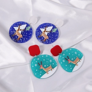Close-up of cute acrylic Christmas earrings featuring reindeer, snowflake and tree motifs