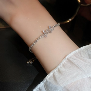 Close-up of elegant zircon butterfly adjustable bracelet with shimmering tennis chain