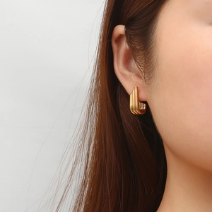 Vintage irregular multilayer gold U-shaped earrings displayed on a model's ear