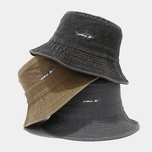 Washed cotton bucket hats with shark embroidery in khaki, charcoal, and dark grey tones