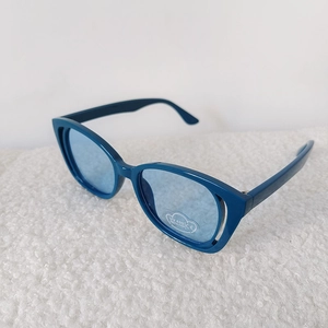 Close-up of kids cat-eye sunglasses with UV400 logo and transparent blue lenses