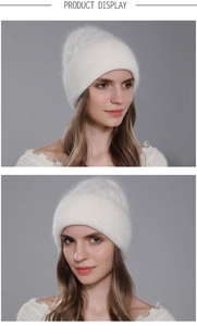 Close-up of white Angora rabbit hair knit beanie with cable patterns and plush texture
