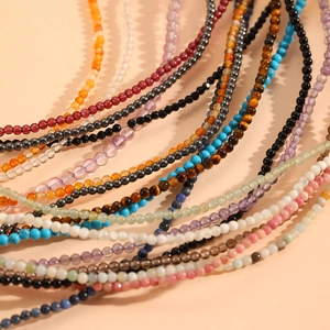 Detailed view of colorful natural crystal beaded anklets with stainless steel accents