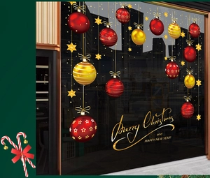 Detail of red and gold Christmas ornaments window stickers with Merry Christmas text