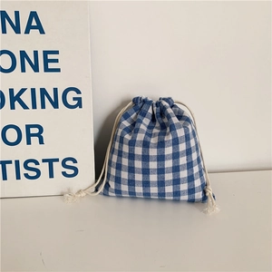 Close-up of blue and white gingham cotton linen drawstring pouch with thick cotton cord