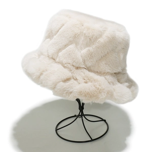 Chic beige faux fur fisherman hat with geometric patterns on a black metal stand