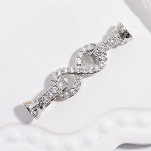 Close-up of infinity shaped 18K gold plated connector clasp with cubic zirconia inlay