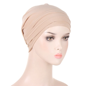 Detail shot of the beige pleated turban hat showing the high-elastic fabric and layers